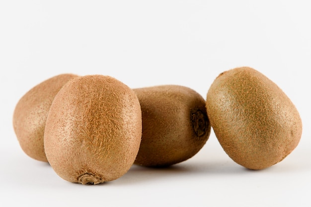 Kiwi fruit slices on white surface