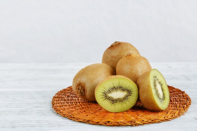 Kiwi fruit on white wooden background