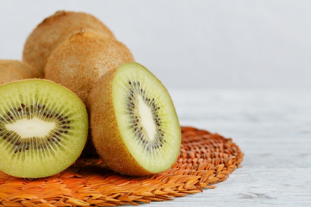 Kiwi fruit on white wooden background