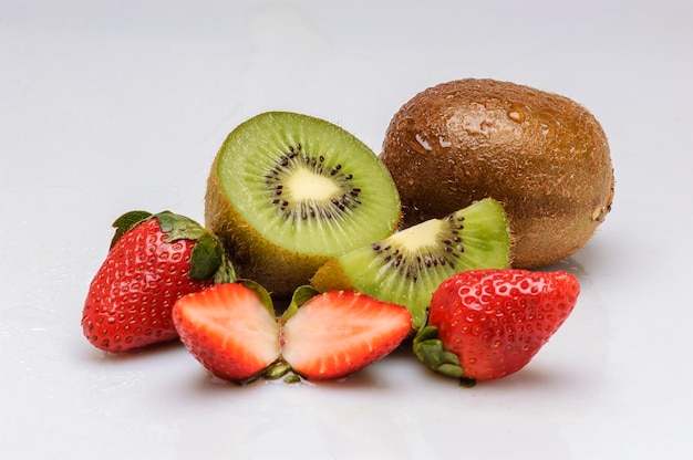 Kiwi fruits and strawberries isolated on white background