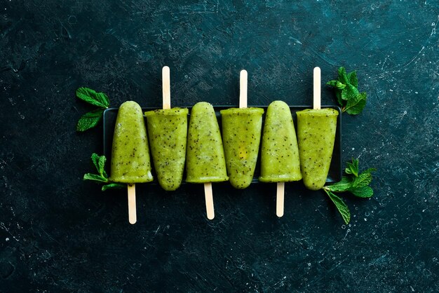 Kiwi Ice Cream Popsicle Top view On a stone background