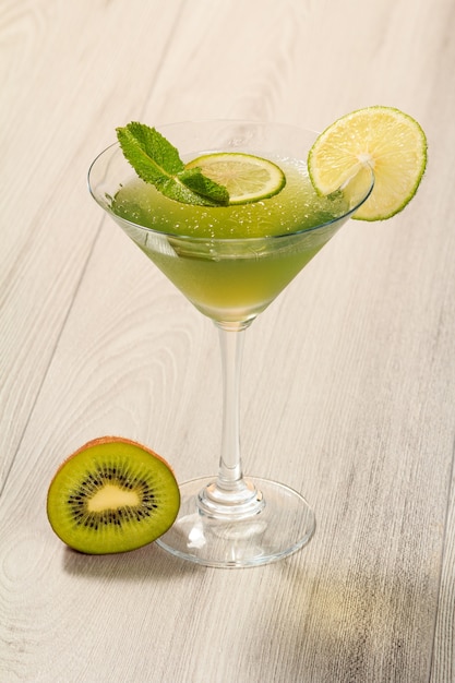 Kiwi jelly with lime pieces in the glass topped with mint leaves