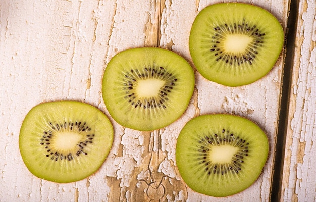 Kiwi kiwi fruit set on rustic wood with rustic fabric selective focus