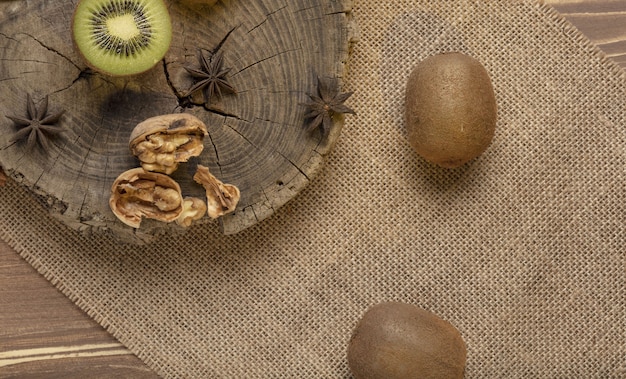 Kiwi and sliced walnut on the wooden