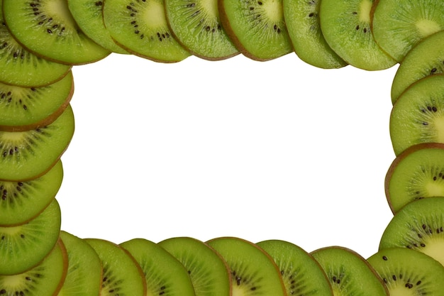 Kiwi slices lie around the entire perimeter of the photo. In the center of the frame is a white clipping background for an inscription or advertisement