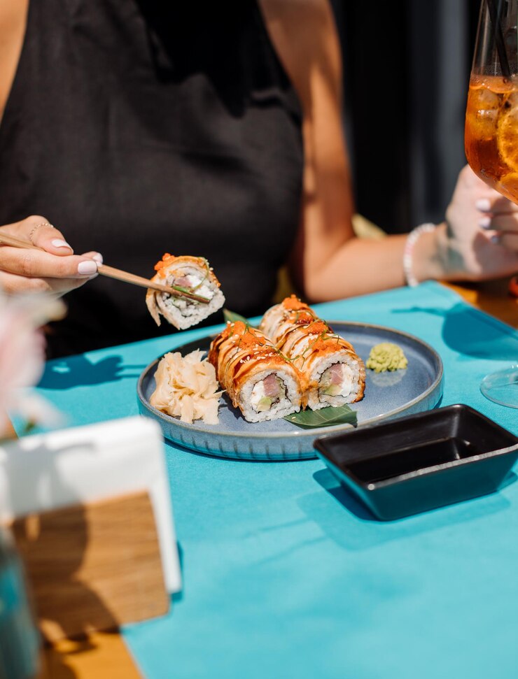 Klant van het restaurant eet sushi-broodjes Close-up
