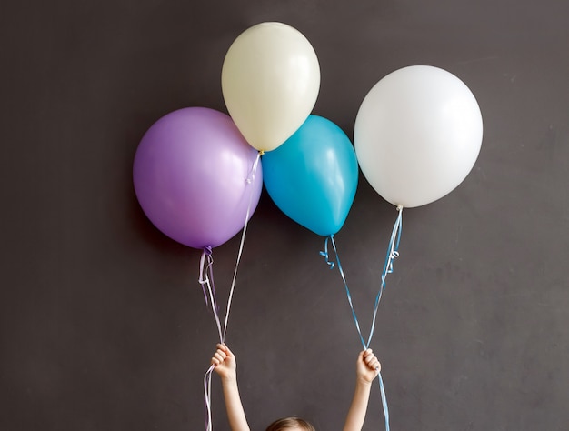 Klein kind met kleurrijke ballonnen