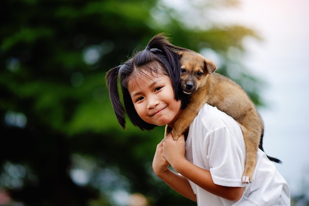 klein meisje en hond Liefde tussen mens en hond Hechting van kinderen en intelligente huisdieren die in het liefdesconcept van de achtertuin spelen