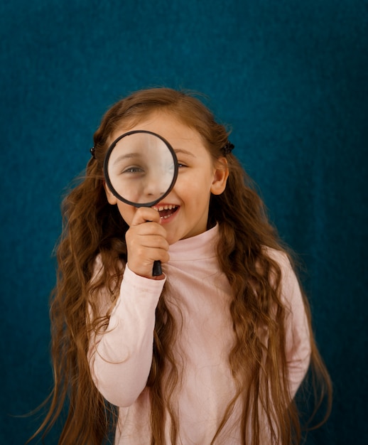 Klein meisje met een vergrootglas