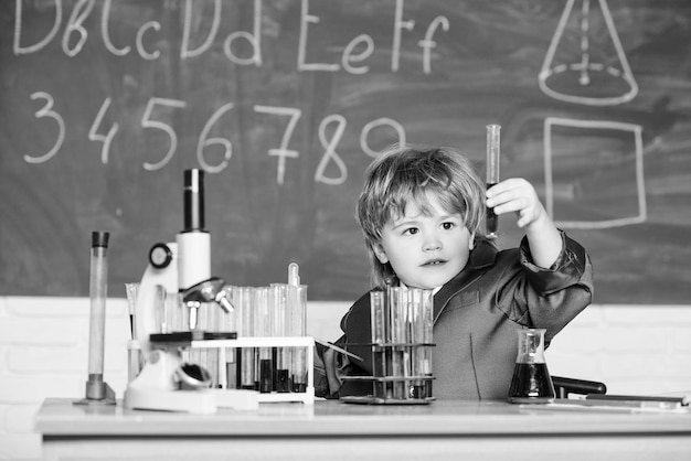 Kleine jongen bij les Terug naar school wetenschapsexperimenten met microscoop in laboratorium Kleine jongen maakt experimenten schoolkind wetenschapper die wetenschap biologie wetenschap bestudeert Wetenschap is het ontdekken waard