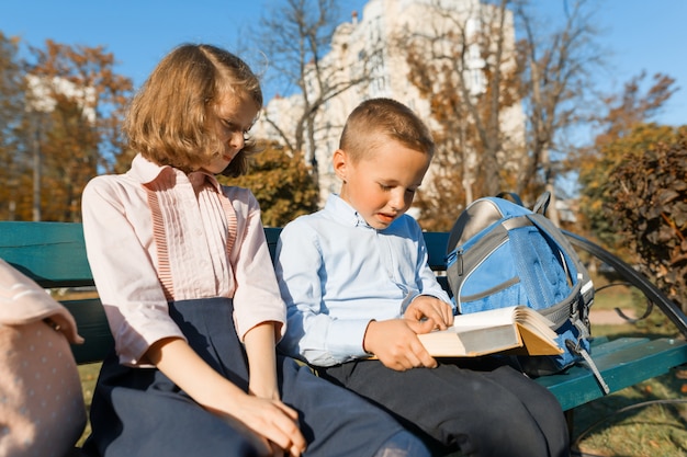 Kleine jongen en meisje schoolkinderen lezen een boek