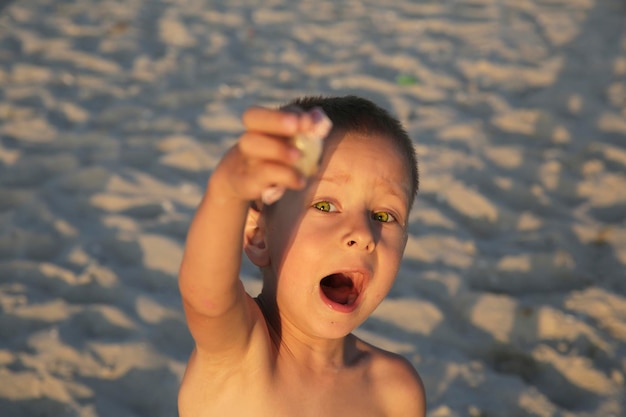 Foto kleine jongen met snoep op de zee