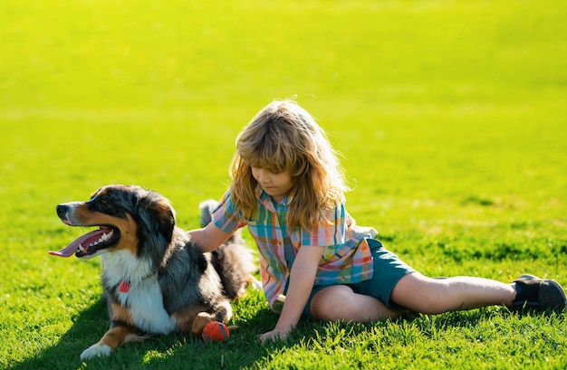 Kleine kindjongen met hond buitenshuis in park Kind met huisdier puppy hondje