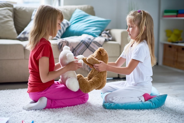 Kleine meisjes spelen met pluchen speelgoed