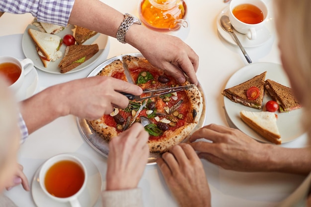 Kleine pizza snijden voor vrienden