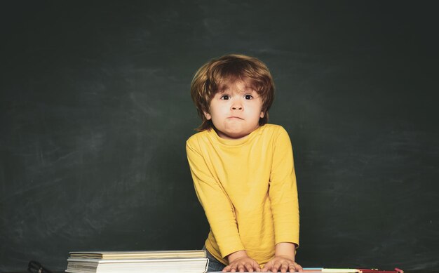 Kleine student jongen blij met een uitstekend cijfer kleuteronderwijs eerste schoolbord achtergrond c