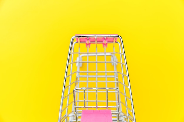 Kleine supermarkt kruidenierskar om te winkelen speelgoed met wielen geïsoleerd op geel kleurrijk trendy