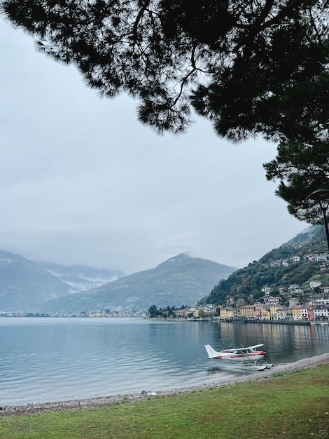 Kleine watervliegtuig staat aan de oevers van het comomeer met villa's in domaso op de achtergrond italië