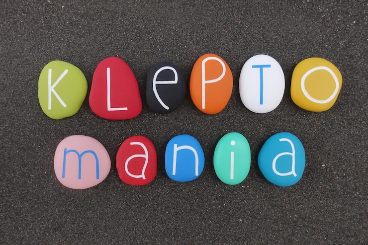 Photo kleptomania text on pebbles