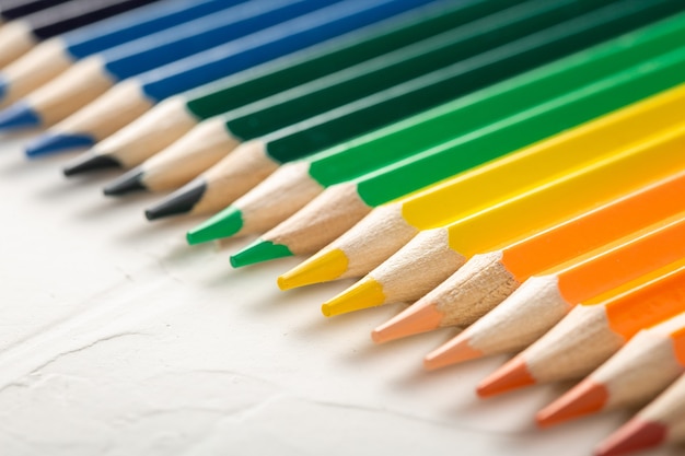 Kleurpotloden op een witte muurclose-up. set potloden met vrije ruimte.