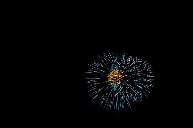 kleurrijk vuurwerk op het zwarte hemelachtergrondoverwater