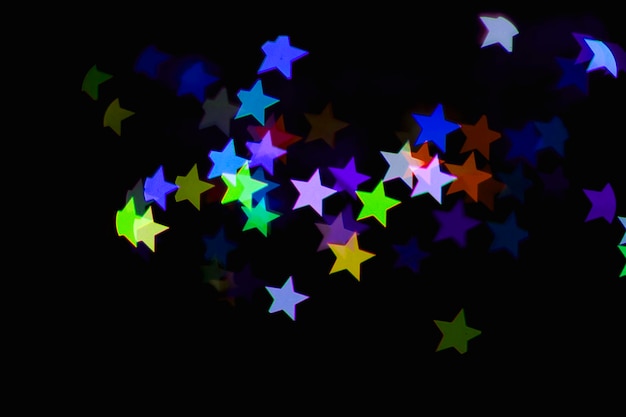 kleurrijke blauwe ster licht effect geïsoleerde overlay glitter textuur op zwart