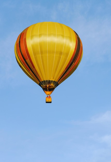 Kleurrijke heteluchtballon in de blauwe lucht met wolken