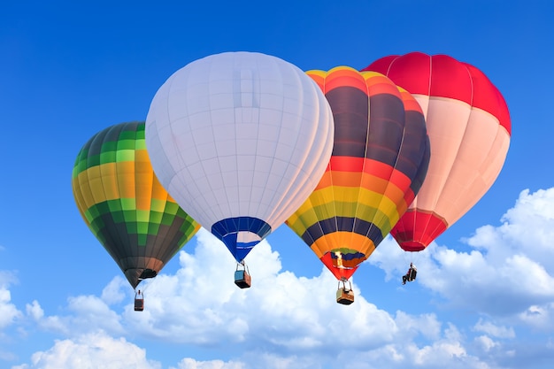 Kleurrijke heteluchtballonnen tijdens de vlucht boven de blauwe lucht