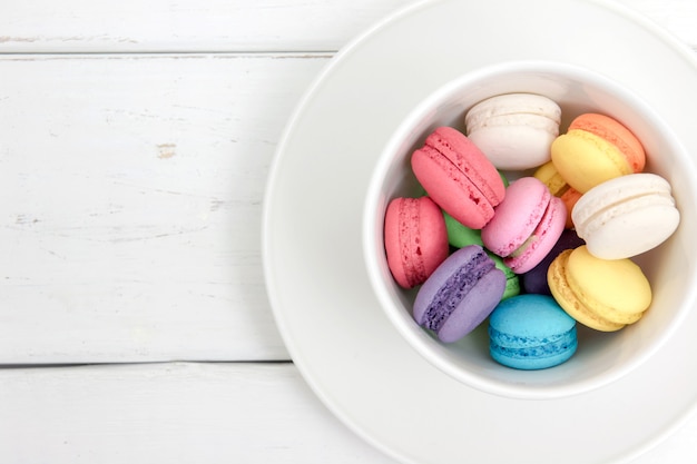 Kleurrijke macarons in een beker met vintage pastel gefilterd