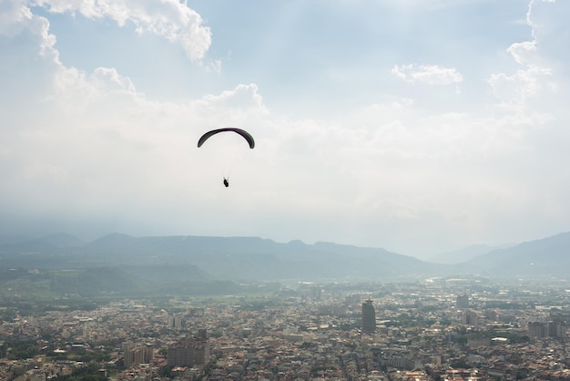 Foto kleurrijke paragliding over de blauwe hemel in de stad