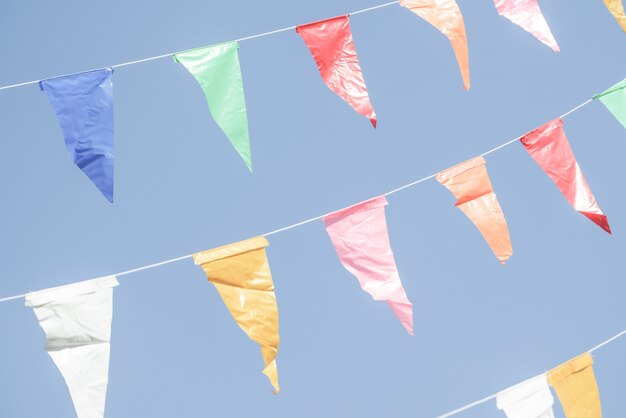 Foto kleurrijke partij vlaggen bunting opknoping op blauwe hemel voor vakantie decoratie