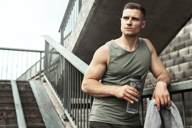 Knappe gespierde man na het joggen op een straat in de stad