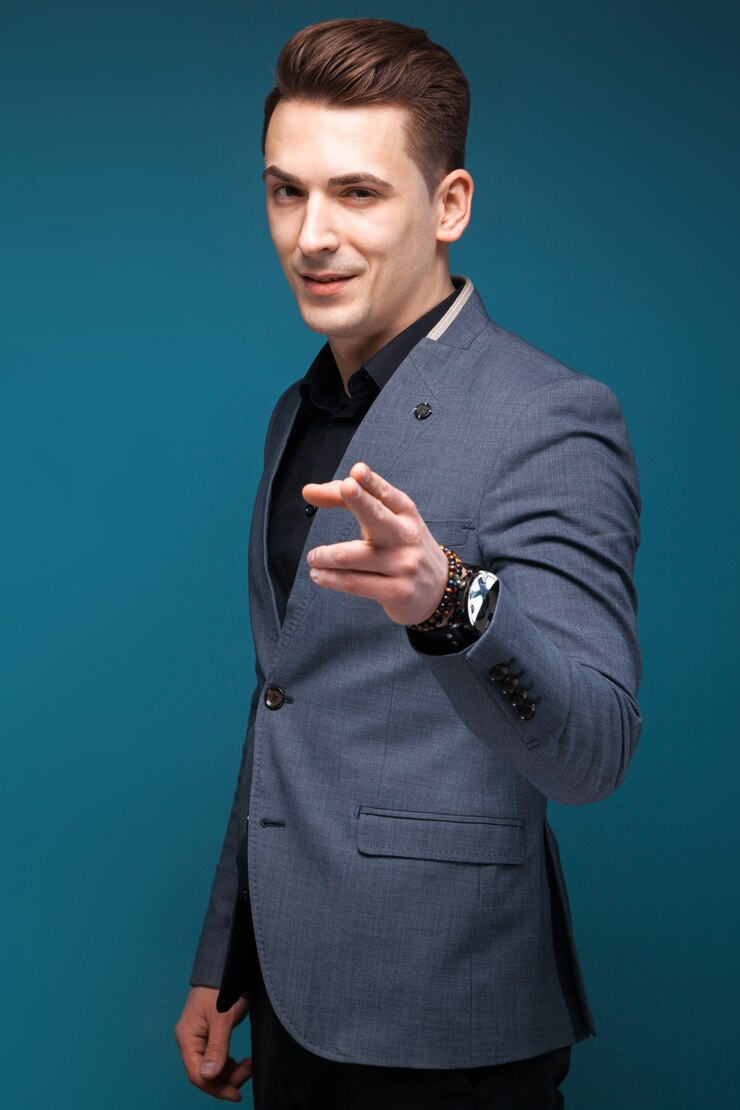 Knappe jonge zakenman in grijs jasje, duur horloge en zwart shirt
