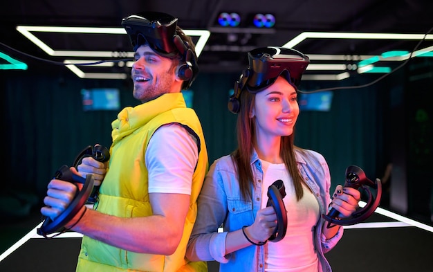 Knappe man en mooie jonge vrouw met een bril van virtual reality. vr, games, entertainment, toekomstig technologieconcept. koppel met virtual reality-headset die samen plezier heeft.