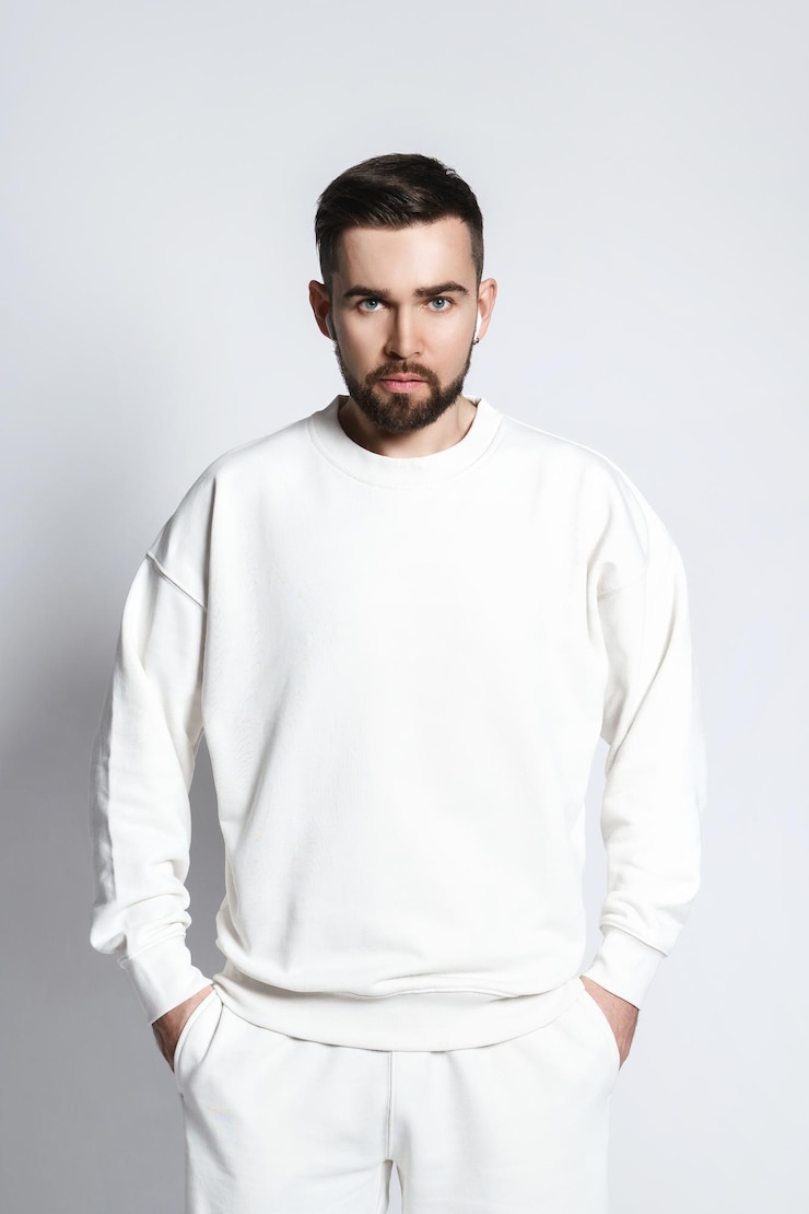 Foto knappe man met een wit sweatshirt met draadloze oordopjes
