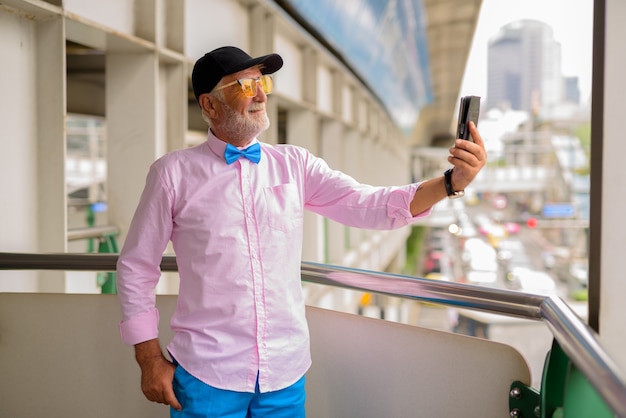 Knappe senior toeristische man verkennen van de stad Bangkok, Thailandia