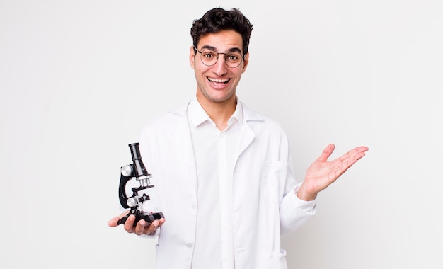 Knappe Spaanse man die blij verrast is en een oplossing of idee-wetenschapper realiseert met een microscoopconcept