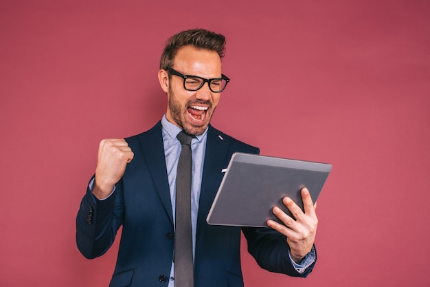 Knappe zakenman die in een tablet werkt