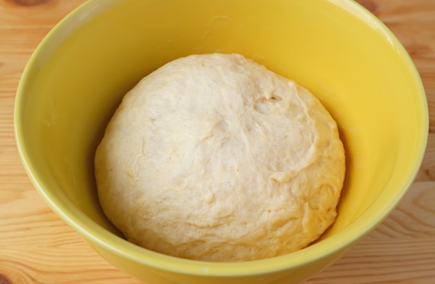 Kneaded dough has risen in the mixing bowl after the rise time