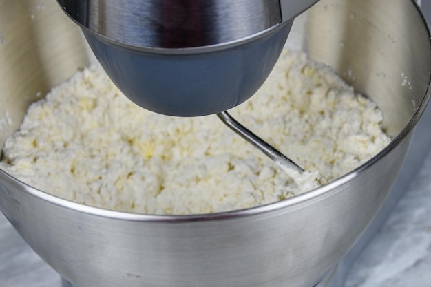 Kneading dough in a modern food processor on a kitchen table