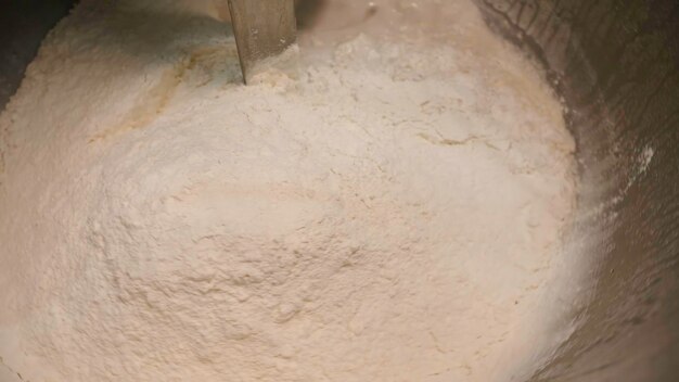 Kneading flour for dough in large mixer stock footage large industrial kneading machines for