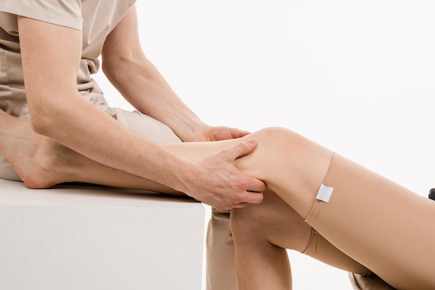 Knee joint and meniscus injury Orthopedist is touching and pressing knee for assessment of the volume of physiological movements Examination of knee mobilisations