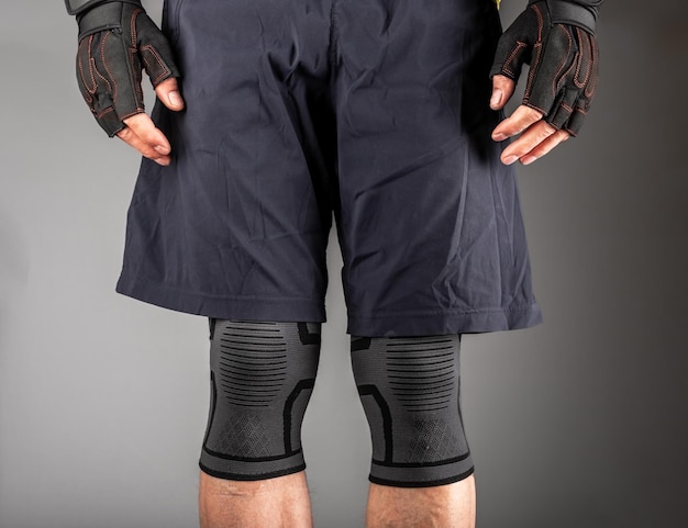 関節の外傷保護とジムでの圧縮のための装具をサポートする ealstic 包帯を身に着けている膝の袖