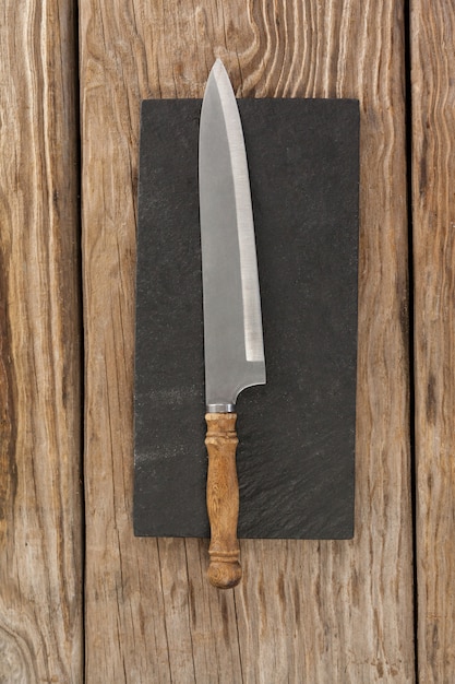 Knife on black slate plate