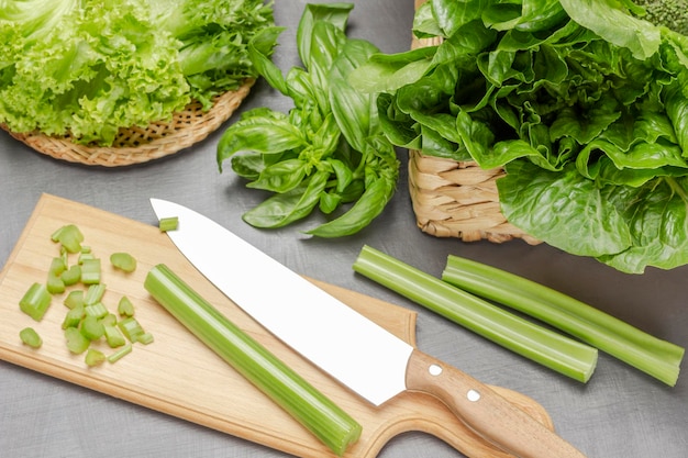 Knife and celery stalks on cutting board