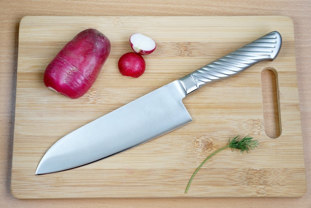 Knife cook universal with a blade like Santoku on a chopping board