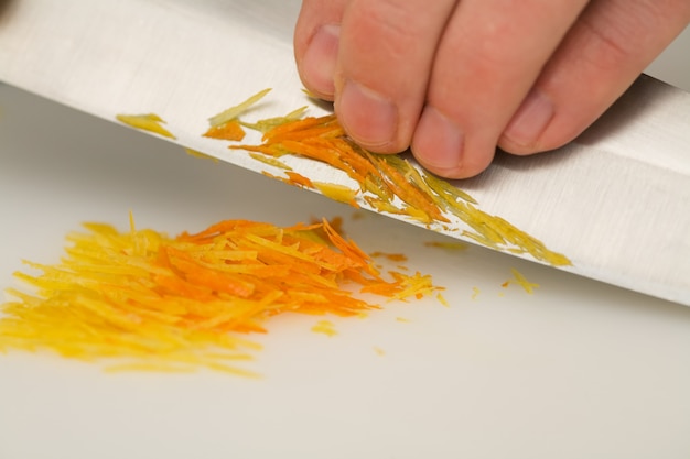 knife cutting orange peel