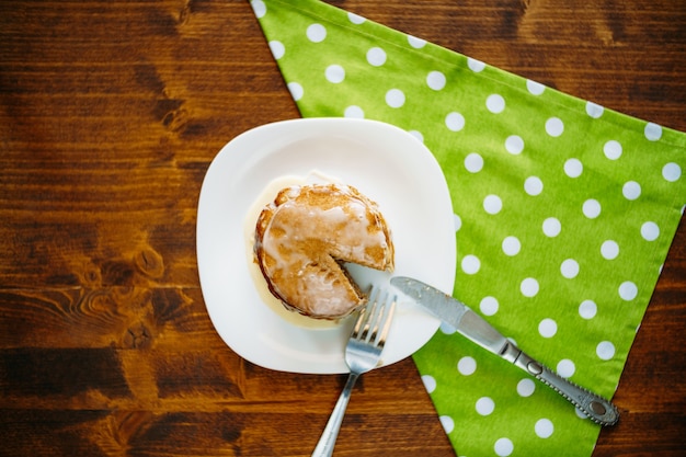 Knife and fork on a cake with dotted napkin