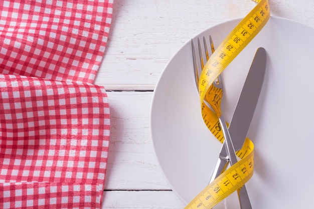 Knife fork spoon tablecloth and plate with tape measure