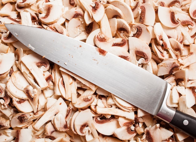 Knife on a pile of cut mushrooms